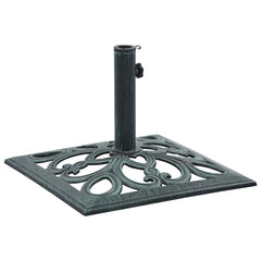Green cast iron umbrella base with decorative scrollwork and adjustable adapter set.