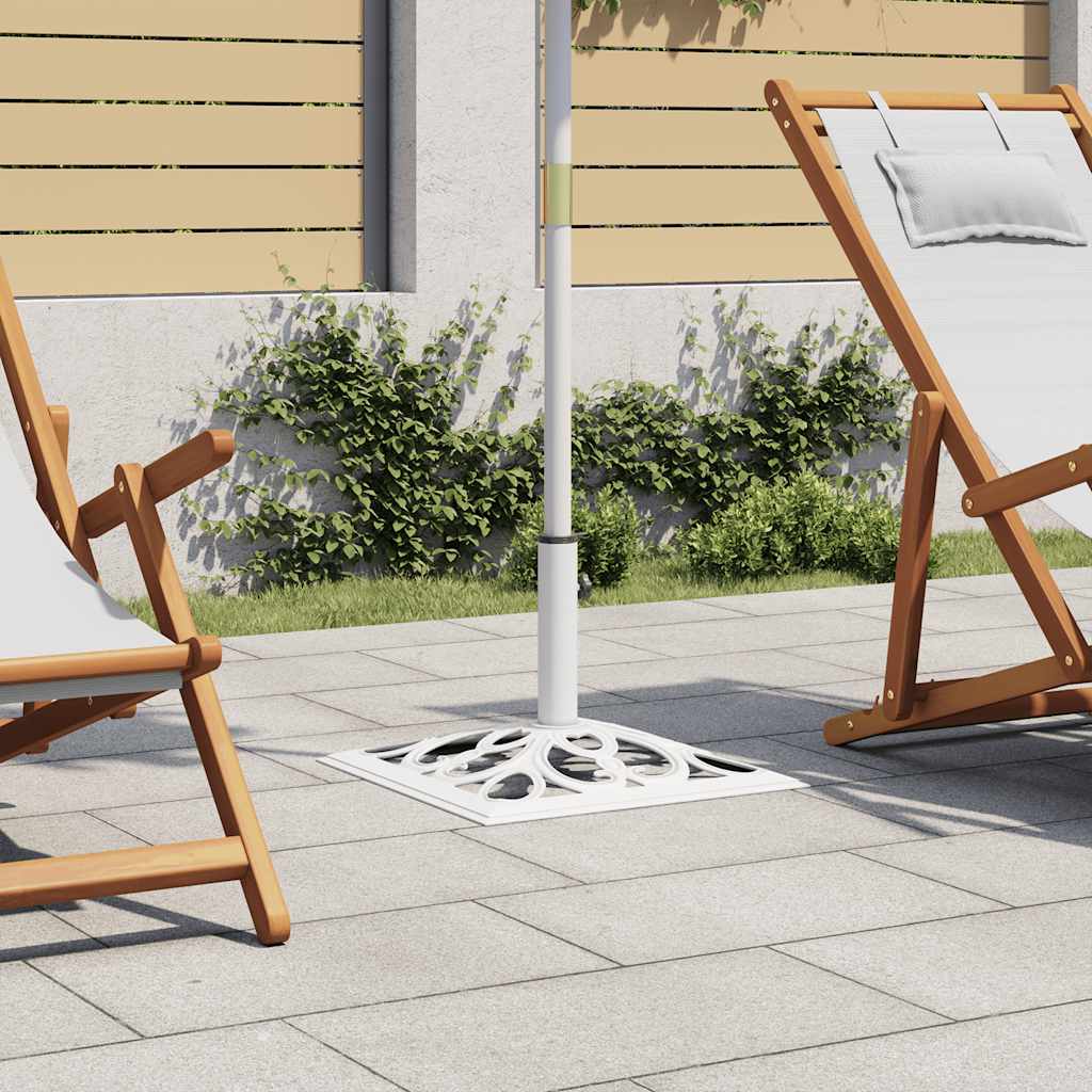 White cast iron umbrella base with scrollwork design, 19.3 inches square, on a patio.