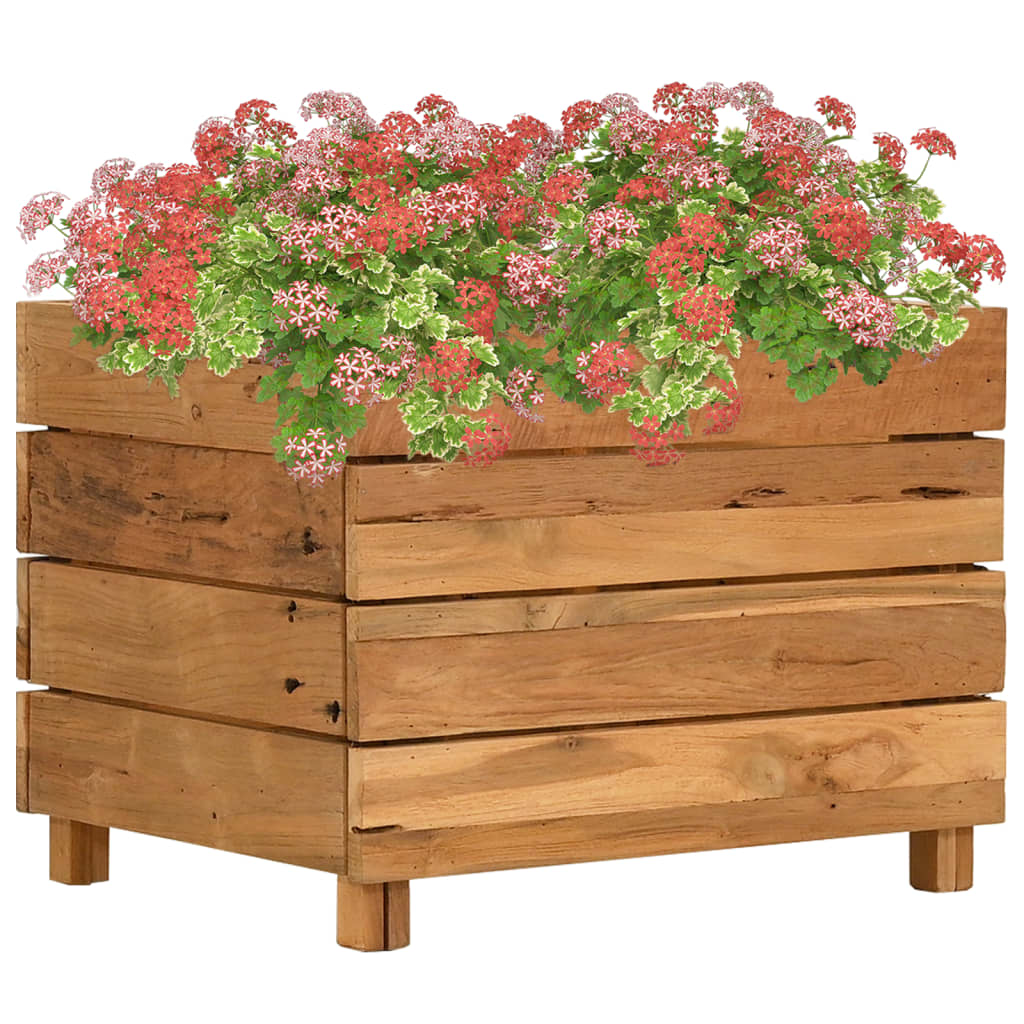 A rectangular raised garden bed made of recycled teak wood, filled with red and pink flowers.