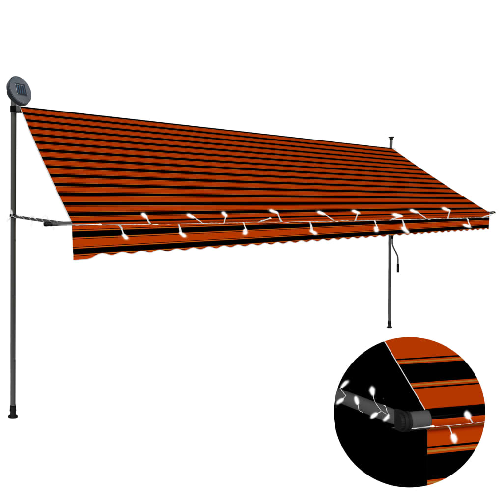 A manual retractable awning with orange and black stripes and an LED light strip.