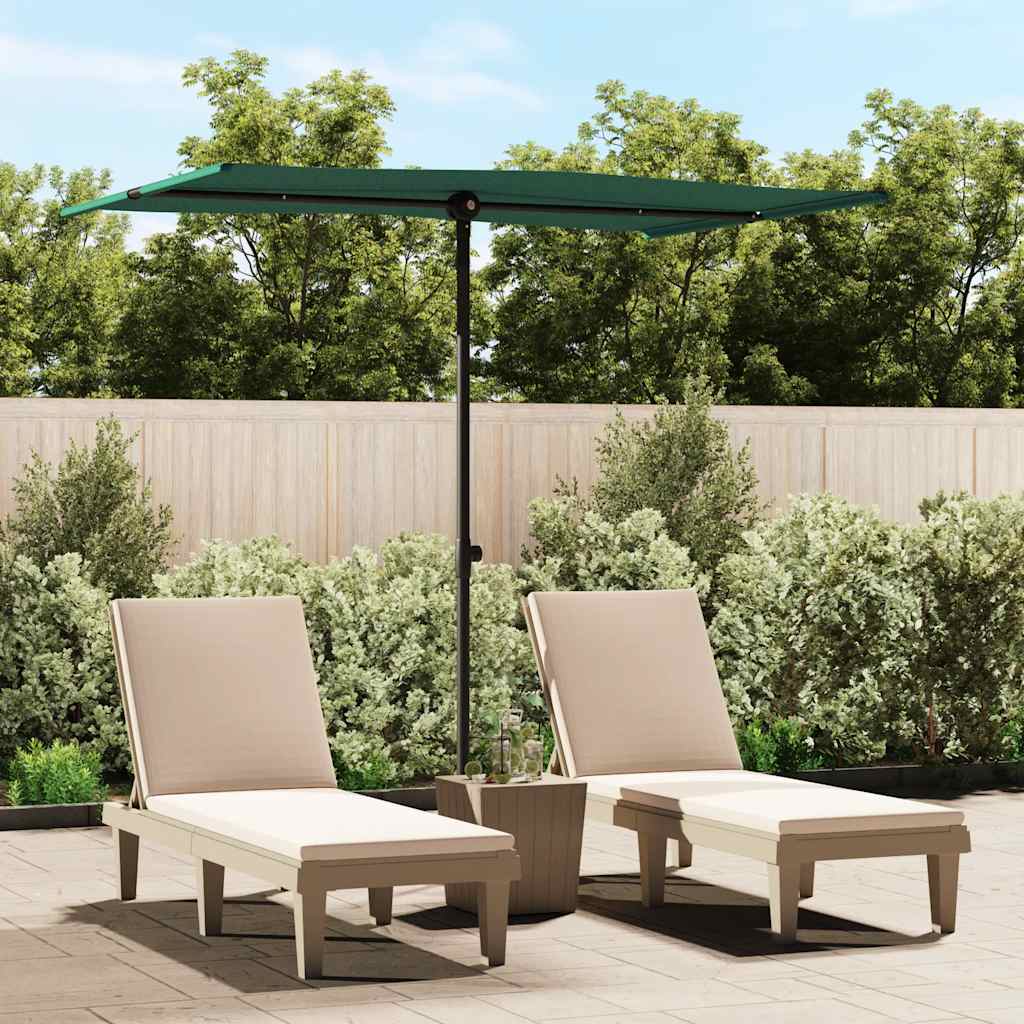 Green garden parasol with aluminum pole shading two beige lounge chairs on a patio.