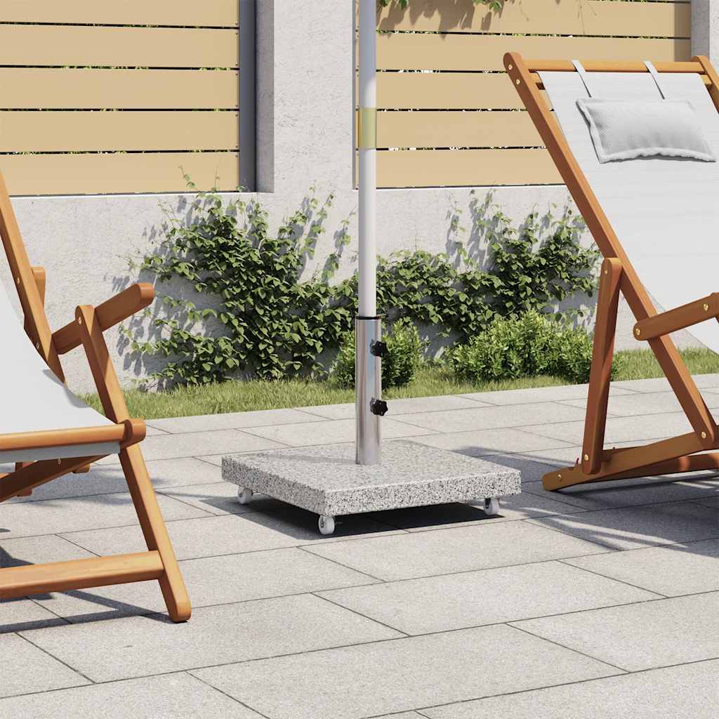 Square gray granite parasol base, 66.1 lb with castors, on patio near wooden chairs.