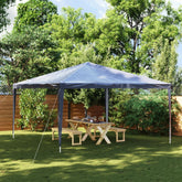 A blue 13.1x13.1 ft party tent with UV water-resistant canopy set up in a backyard over a wooden picnic table.