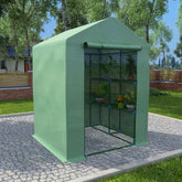 A green steel greenhouse with shelves, measuring 56.3x56.3x76.8 inches, in a garden setting.