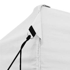 Close-up of white folding party tent corner with black rope and steel ring attachment.