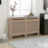 Beige MDF radiator cover with slatted design and shelf, in a modern living room.