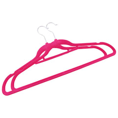 Two pink velvet clothes hangers with silver swivel hooks and trouser bars.