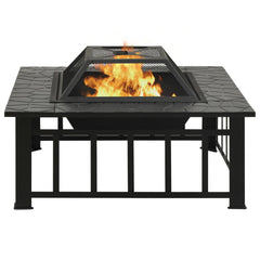 Square black steel garden fire pit with burning flames and vented lid on stone-patterned base.