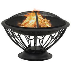 A black steel fire pit with swirling legs, burning logs, and a mesh cover.