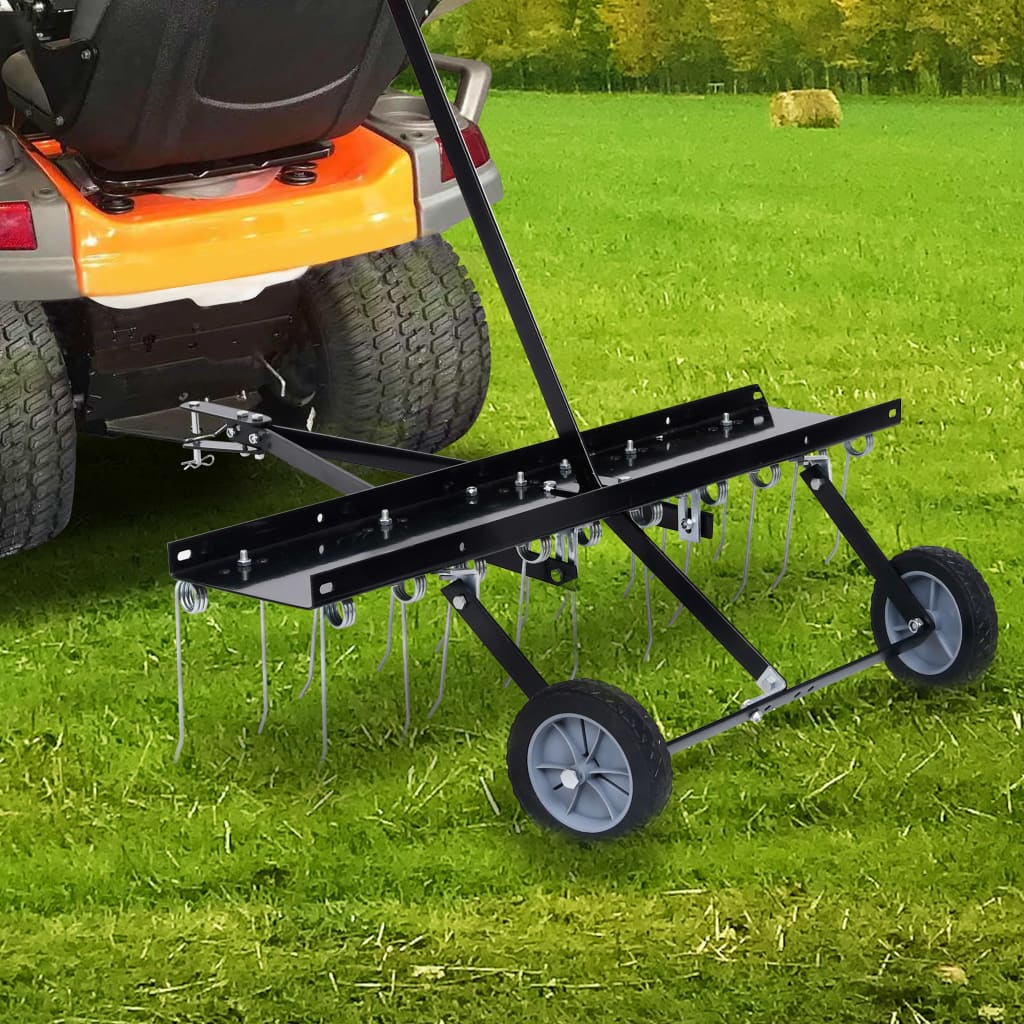 39.4-inch steel tine scarifier attached to rear of orange ride-on mower on green lawn.