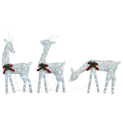 A family of three reindeer decorated with cold white LED lights for outdoor holiday display.