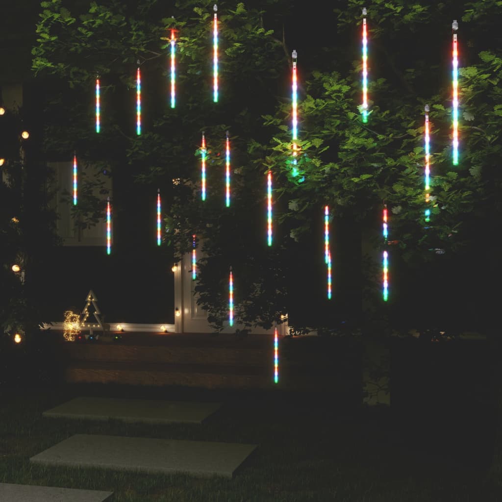 20 colorful LED meteor rain lights hanging from a tree at night, creating a twinkling shower effect.