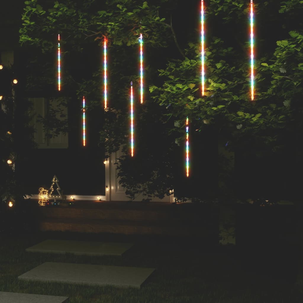 Eight 2-foot colorful LED meteor rain lights hanging from a tree at night, creating a cascading rainbow shower effect.