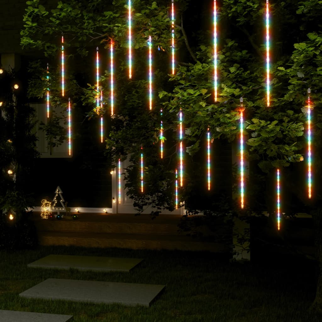 20 colorful meteor rain lights with 720 LEDs cascading from a tree at night.