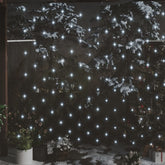 Bostome Christmas LED net lights with 204 cold white LEDs, 9.8 by 6.6 feet, draped on snowy outdoor trees and plants.