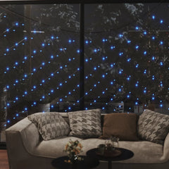 Blue LED Christmas net lights draped over a window, illuminating a cozy living room with 204 LEDs in a 9.8'x6.6' mesh.