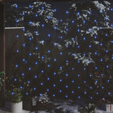 Blue LED Christmas net lights, 9.8 by 6.6 feet with 204 LEDs, draped on snowy trees outdoors.