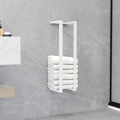 White steel towel rack mounted on bathroom wall, holding stacked white towels.