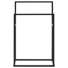 Black iron freestanding towel rack with two tiers for organized bathroom storage.
