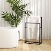 Black iron 2-tier freestanding towel rack with a white towel.