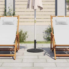 A black cast iron umbrella base stands between two white lounge chairs on a patio.