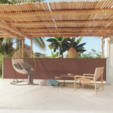 Brown retractable side awning with a sturdy steel base for outdoor privacy and shade.