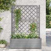 Stone gray garden planter with trellis holding green climbing plants and flowers.