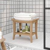 Solid teak wood bathroom side table with lower shelf, holding towel, soap, and loofah.