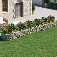 Galvanized iron gabion raised bed with stone walls, red flowers, and outdoor seating.