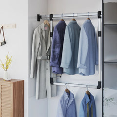 Silver adjustable telescopic wardrobe rail with hangers holding shirts and coats in a closet.