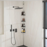 Silver aluminum 4-tier adjustable telescopic shower corner shelf with rust-proof trays mounted in a bathroom corner.