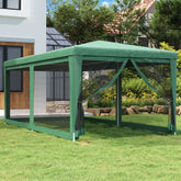 Green HDPE party tent with mesh sidewalls set up on a lawn near a house.