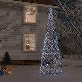 A 16-foot tall outdoor Christmas cone tree with 1400 cold white LEDs, set up in snowy yard beside a house.