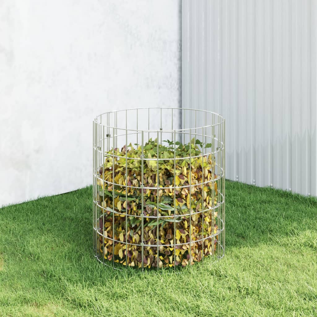 Galvanized steel garden composter with open grid design filled with leaves on grass.