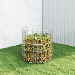 Galvanized steel garden composter with open grid design filled with leaves on grass.