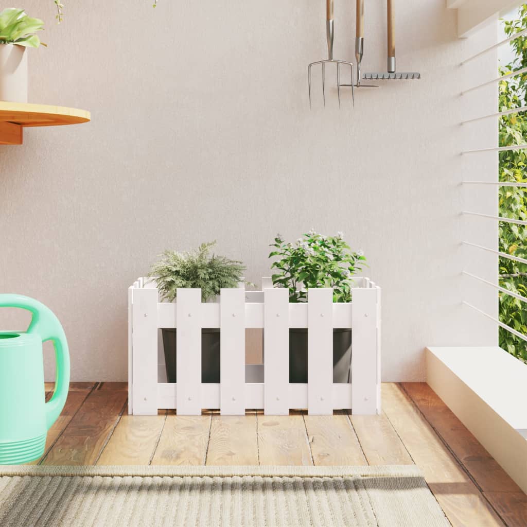 White solid pine garden planter with fence design holding two green plants.