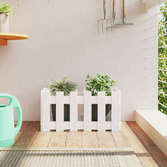 White solid pine garden planter with fence design holding two green plants.