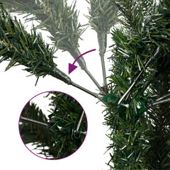 Close-up of green artificial Christmas tree branches with real pinecones and hinged metal supports.