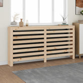 A light pine wood radiator cover with horizontal slats, placed against a wall near a window.