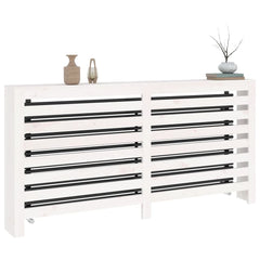White solid pine wood radiator cover with horizontal slats and decorative items on top.