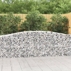 Arched galvanized iron gabion baskets filled with stones, forming a curved garden wall.