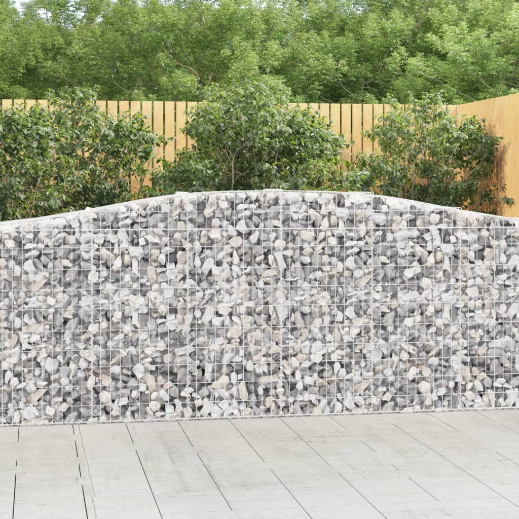 Two galvanized iron arched gabion baskets filled with light gray stones.