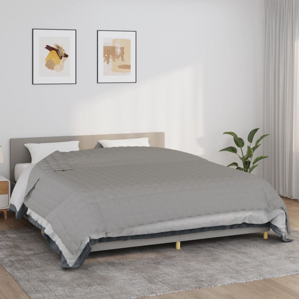 Gray cotton weighted blanket on a bed, 86.6x102.4 inches, 33.1 pounds.