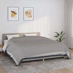 Gray cotton weighted blanket on a bed, 86.6x102.4 inches, 33.1 pounds.