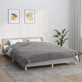Gray 33.1 lb Bostome weighted blanket on a queen bed with beige pillows.