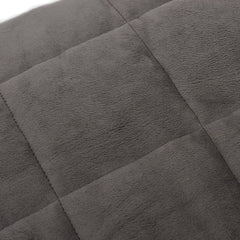 Gray weighted blanket with quilted stitching and plush fabric texture.