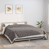 Gray Bostome weighted blanket on a bed, measuring 86.6x102.4 inches and weighing 33.1 pounds.