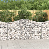 Arched galvanized iron gabion basket wall filled with rocks, 78.7x11.8x39.4/47.2 inches, in garden setting.