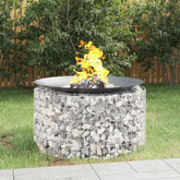A 39.4-inch galvanized iron gabion fire pit filled with stones and burning flames in a backyard.