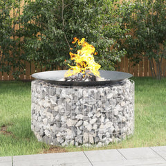 A 39.4-inch galvanized iron gabion fire pit filled with stones and burning flames in a backyard.